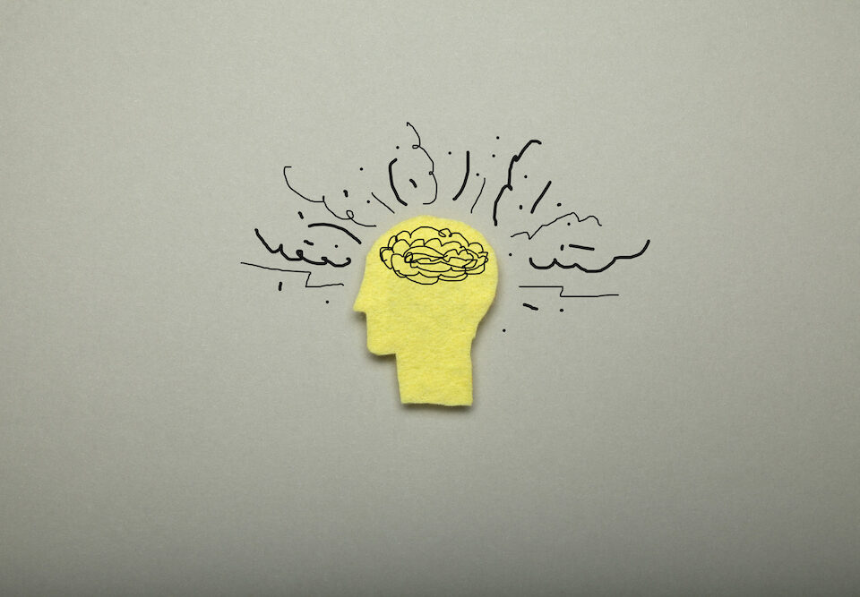 Image of a person's head with an illustration depicting stress and overload in their brain.
