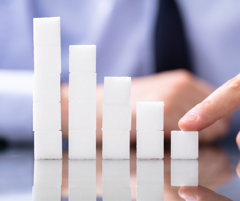 Hand pointing to descending stacked cubes symbolising reduction — visual metaphor for decreasing workplace injuries or claims